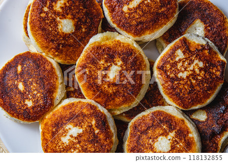 Fresh fried cottage cheese pancakes on a white plate 118132855