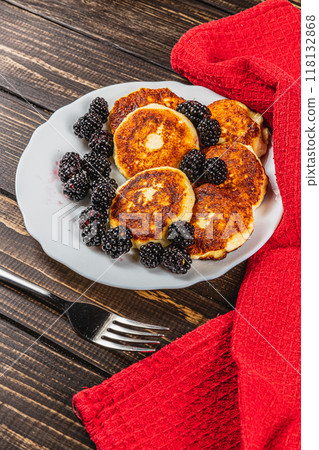 Cottage cheese pancakes with fresh blackberries on a white flat white plate Cottage cheese pancakes with fresh blackberries on a white flat white plate 118132868