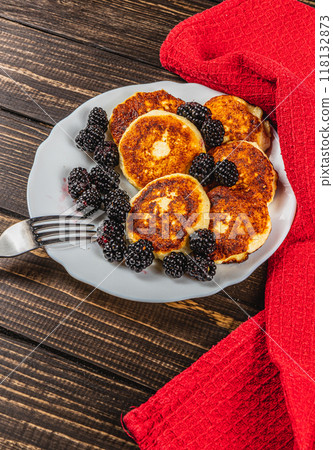 Cottage cheese pancakes with fresh blackberries on a white flat white plate Cottage cheese pancakes with fresh blackberries on a white flat white plate 118132873