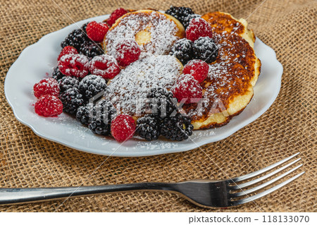 Cottage cheese pancakes with fresh raspberries, blackberries and powdered sugar Cottage cheese pancakes with fresh raspberries, blackberries and powdered sugar 118133070