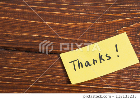 yellow sticky note with the word thanks written on it. 118133233