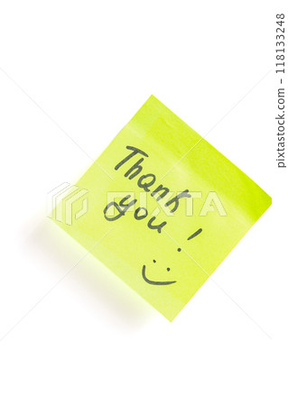 The word thank you with a smiley face on acid green paper on a white background 118133248