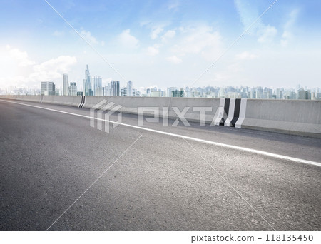 Empty asphalt road with cityscape background Empty asphalt road with cityscape background 118135450