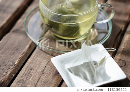 Hot green tea brewed in a triangular tea bag Hot green tea brewed in a triangular tea bag 118136221