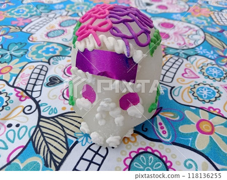 A skeleton ornament on a skeleton-patterned cloth (Mexico, Day of the Dead) A skeleton ornament on a skeleton-patterned cloth (Mexico, Day of the Dead) 118136255