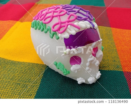 "Mexican Day of the Dead" - A sugar skull on a colorful Mexican cloth 118136490