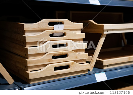 Wooden breakfast tray on the shelf in the store. Environmental friendliness. Reuse. Handmade work. 118137166