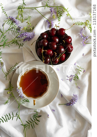 Fresh sweet cherries bowl with leaves in water drops on stone background, top view Fresh sweet cherries bowl with leaves in water drops on stone background, top view 118137168