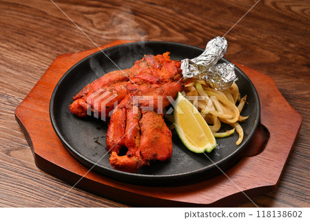 Note: Steam is synthetic. Tandoori chicken, Indian cuisine, spiced grilled chicken on the bone Note: Steam is synthetic. Tandoori chicken, Indian cuisine, spiced grilled chicken on the bone 118138602