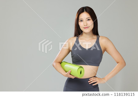 A woman with a yoga mat A woman with a yoga mat 118139115