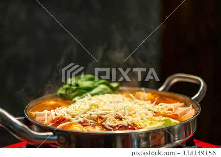 Korean hot pot, Ramyeon and Tteokbokki in Kimchi soup with vegetable, meat and cheese on top Korean hot pot, Ramyeon and Tteokbokki in Kimchi soup with vegetable, meat and cheese on top 118139156