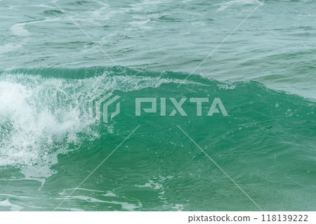 Wave of the green and blue Atlantic Ocean at the edge of a beach in the Iroise Sea. Wave of the green and blue Atlantic Ocean at the edge of a beach in the Iroise Sea. 118139222