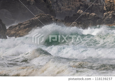 Large waves of the Atlantic Ocean crash against the rocks of a cliff Large waves of the Atlantic Ocean crash against the rocks of a cliff 118139237