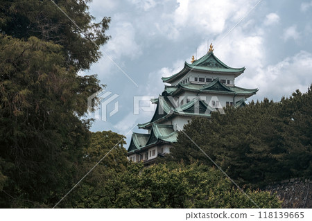 A cinematic-style picture of majestic Nagoya Castle, crowned with golden shachihoko, reflects Japan's rich history and the beauty of its Edo-era architecture, surrounded by serene gardens. A cinematic-style picture of majestic Nagoya Castle, crowned with golden shachihoko, reflects Japan's rich history and the beauty of its Edo-era architecture, surrounded by serene gardens. 118139665