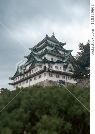 A cinematic-style picture of majestic Nagoya Castle, crowned with golden shachihoko, reflects Japan's rich history and the beauty of its Edo-era architecture, surrounded by serene gardens. A cinematic-style picture of majestic Nagoya Castle, crowned with golden shachihoko, reflects Japan's rich history and the beauty of its Edo-era architecture, surrounded by serene gardens. 118139668