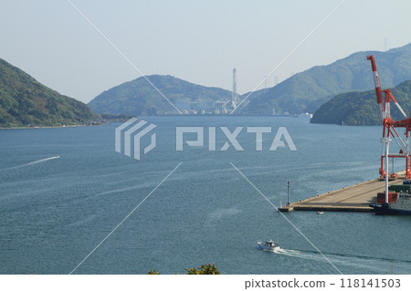 Container yard and departing fishing boat 118141503