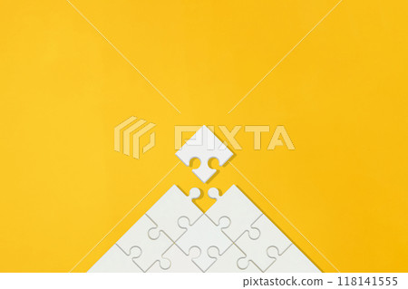 Orange background with blank white arrow-shaped puzzle pieces Orange background with blank white arrow-shaped puzzle pieces 118141555
