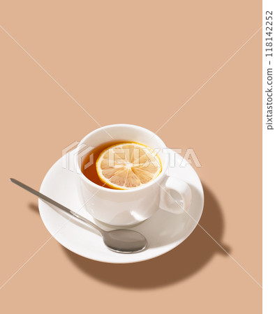 A cup of tea with lemon on a isolated brown background. Healthy drink concept. 118142252