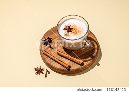 Traditional Indian masala chai latte in a glass cup. Hot drink with milk, spices and herbs Traditional Indian masala chai latte in a glass cup. Hot drink with milk, spices and herbs 118142423
