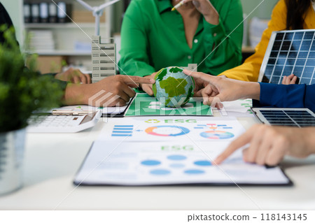 colleagues discussing data working and tablet, laptop with on Construction Site project, green energy and solar panel concept. 118143145