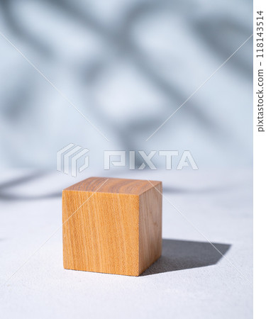 Wooden cube empty for product demonstration or mock-up with shadows on a blue background. 118143514