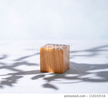 Wooden cube empty for product demonstration or mock-up with shadows on a blue background. Wooden cube empty for product demonstration or mock-up with shadows on a blue background. 118143516