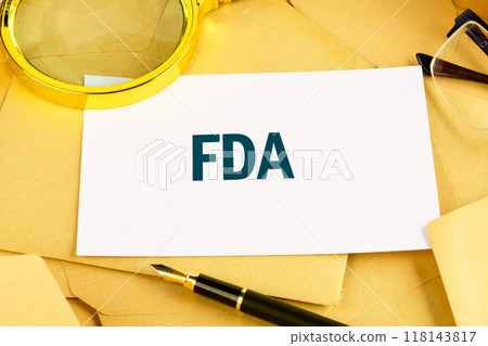 Food and Drug Administration (FDA) is a federal agency of the Department of Health and Human Services. FDA on the card against the background of scattered envelopes Food and Drug Administration (FDA) is a federal agency of the Department of Health and Human Services. FDA on the card against the background of scattered envelopes 118143817