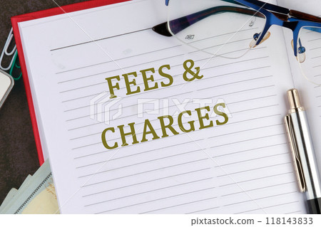 Business concept. FEES and CHARGES words there is a memo for analysis in the business notebook Business concept. FEES and CHARGES words there is a memo for analysis in the business notebook 118143833