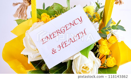 EMERGENCY and HEALTH written on a white card on a background of flowers EMERGENCY and HEALTH written on a white card on a background of flowers 118143862