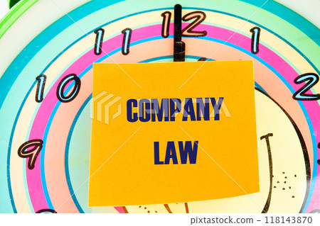 Business, accounting and real estate concept. COMPANY LAW written on the sticker on the background of the clock face with hands 118143870