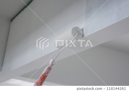 using paint roller for paint building wall 118144261