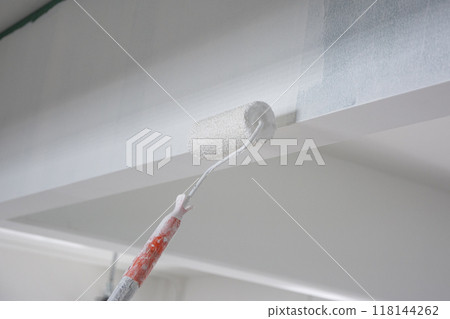 using paint roller for paint building wall 118144262