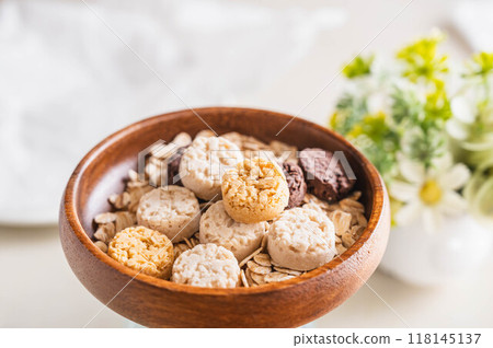 Sweets and oatmeal in a wooden bowl 118145137