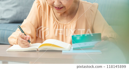 Worried senior woman, bankbook, end of life planning Worried senior woman, bankbook, end of life planning 118145899