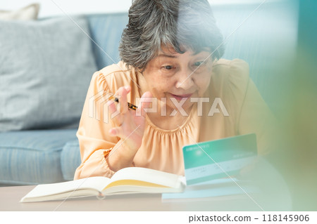 Worried senior woman, bankbook, end of life planning Worried senior woman, bankbook, end of life planning 118145906