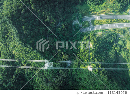 Aerial view of electricity tower on mountain 118145956