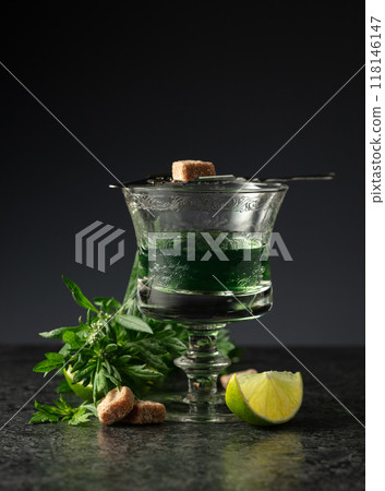 Glass of absinthe with ingredients on a black background. Glass of absinthe with ingredients on a black background. 118146147