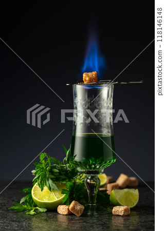 Burning sugar on a glass with absinthe. Burning sugar on a glass with absinthe. 118146148