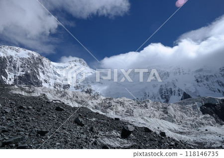 Tranquil Lake With Lush Green Forest, Snow-Capped Mountain, Blue Sky And White Clouds 118146735