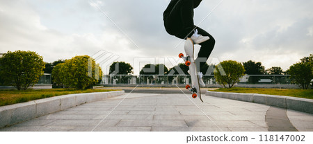 Skateboarder skateboarding in modern city 118147002