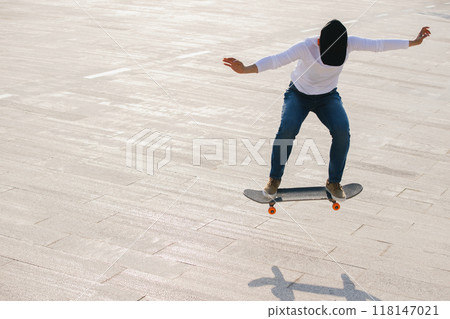 Skateboarder skateboarding outdoors in city 118147021