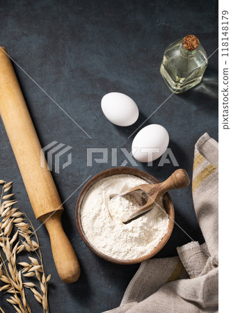 Organic ingredients for baking, oat flour, oil, eggs, rolling pin and kitchen textiles Organic ingredients for baking, oat flour, oil, eggs, rolling pin and kitchen textiles 118148179