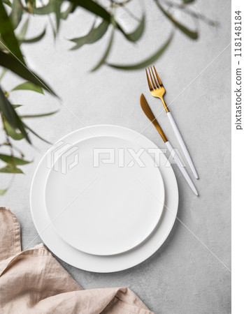 Festive table setting with empty white plate and  cutlery for holiday with eucalyptus branches 118148184