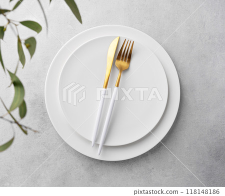Festive table setting with empty white plate and  cutlery for holiday with eucalyptus branches 118148186
