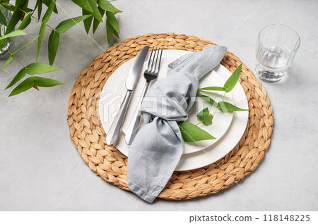 Festive table setting with white plates and glass for a spring celebration, wedding, birthday  118148225