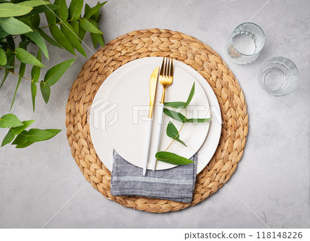 Festive table setting with white plates and glasses for a spring celebration, wedding, birthday  118148226