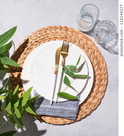 Festive table setting with white plates and glasses for a spring celebration, wedding 118148227