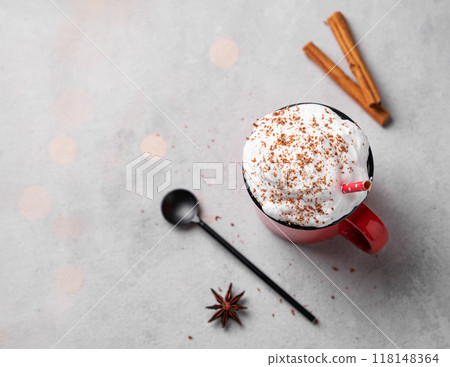 Red mug with hot chocolate or cocoa with whipped cream, with spoon, cinnamon sticks and star anise Red mug with hot chocolate or cocoa with whipped cream, with spoon, cinnamon sticks and star anise 118148364