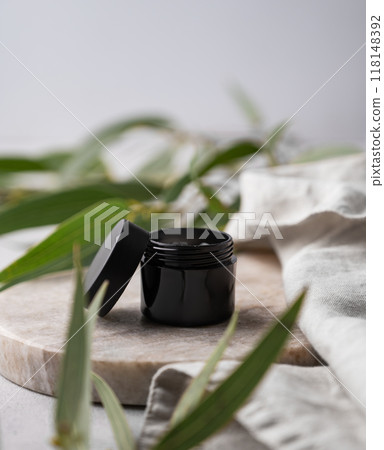 Organic cosmetic mask or cream for body and face skin in a black jar on a marble board Organic cosmetic mask or cream for body and face skin in a black jar on a marble board 118148392