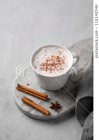 White mug of hot cocoa or chocolate with whipped cream, cinnamon sticks and star anise White mug of hot cocoa or chocolate with whipped cream, cinnamon sticks and star anise 118148546